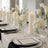 Elegant white wedding table setting with candles and floral centerpieces