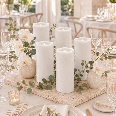 Elegant white candle centerpiece with orchids and eucalyptus on a luxury dinner table