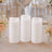 Three flameless LED pillar candles with floral wedding table decor