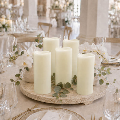 Elegant wedding table centerpiece with candles, orchids, and eucalyptus greenery