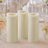 Three ivory LED pillar candles with floral wedding table decor