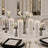 Elegant white floral wedding table centerpiece with candles and glassware