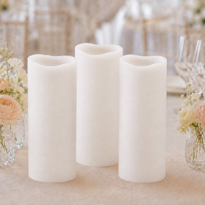 Elegant flameless white pillar candles with floral wedding table decor