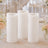 Elegant flameless white pillar candles with floral wedding table decor
