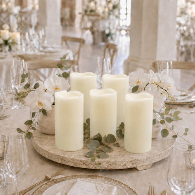 Elegant wedding table centerpiece with candles, orchids, and eucalyptus greenery