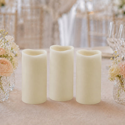 Three ivory flameless candles with floral wedding table decor