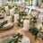 Elegant garden wedding reception table with candles, flowers, and gold flatware