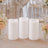 Three white flameless pillar candles with floral wedding table decor