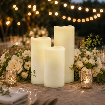 Elegant candlelit floral wedding table centerpiece with roses and string lights