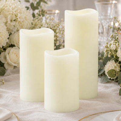 Cream flameless LED candles with floral wedding table centerpiece
