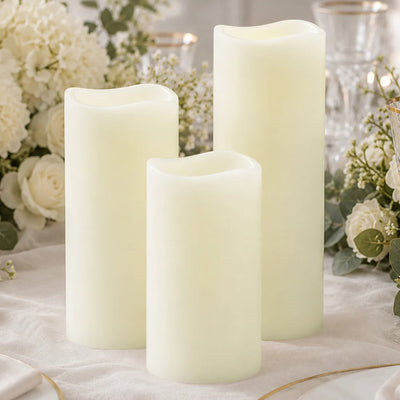 Elegant ivory LED pillar candles with floral wedding decor