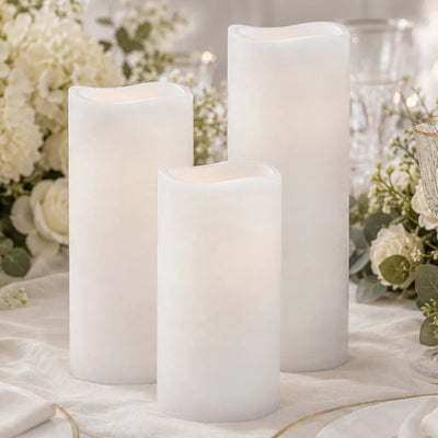 White LED flameless candles with wavy tops on a floral table setting