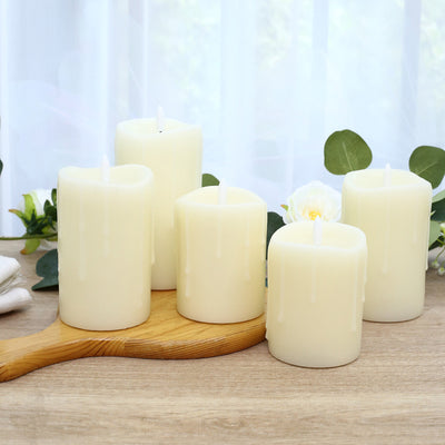 Five ivory pillar candles with eucalyptus on a wooden tray, spa decor
