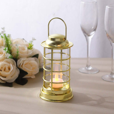Gold lantern with a candle, surrounded by flowers and glassware.
