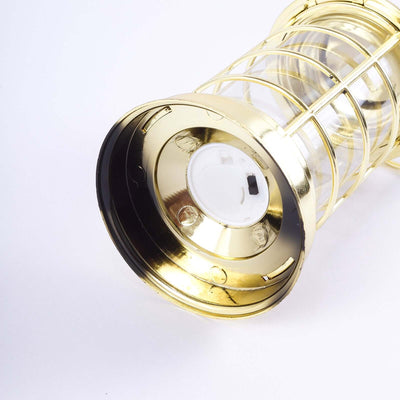 Gold lantern with glass and metal design, studio shot.