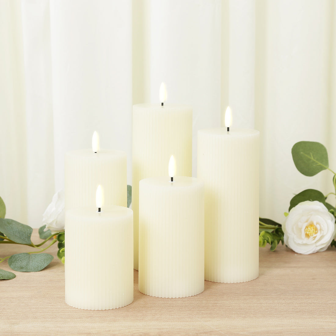 Set of five flameless ivory candles with realistic flickering flames.