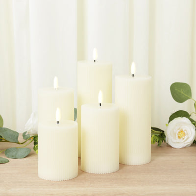 Set of five flameless ivory candles with realistic flickering flames.