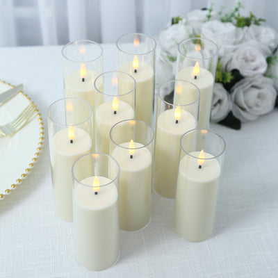 Elegant white LED candles in glass holders with floral wedding decor