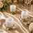 Elegant gold candle holders with white candles on a luxury wedding table setting