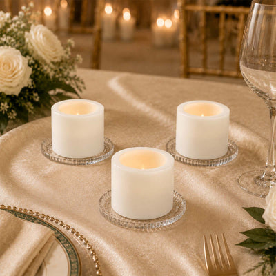 Elegant gold wedding table setting with candles, flowers, and glassware