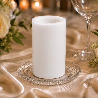 White LED flameless pillar candle on elegant table setting.