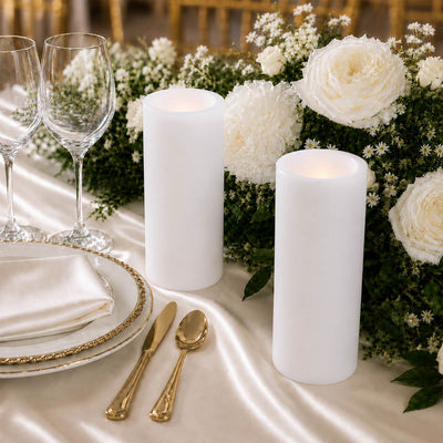 Elegant white wedding table setting with candles, flowers, and gold accents