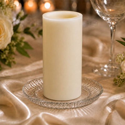 Elegant ivory pillar candle centerpiece on a gold satin table setting