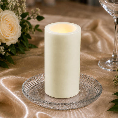 Elegant ivory LED flameless candle on decorative glass plate with flowers