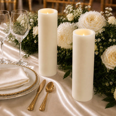 Elegant gold and white wedding table setting with candles and floral centerpiece