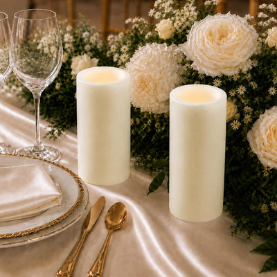 Elegant ivory candlelit wedding table with white flowers and gold tableware