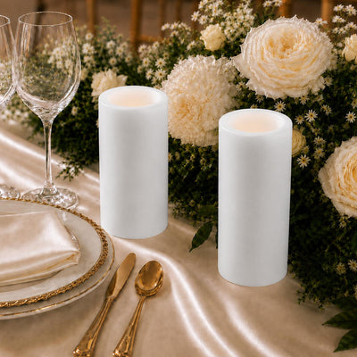 Elegant wedding table setting with white candles, flowers, and gold accents
