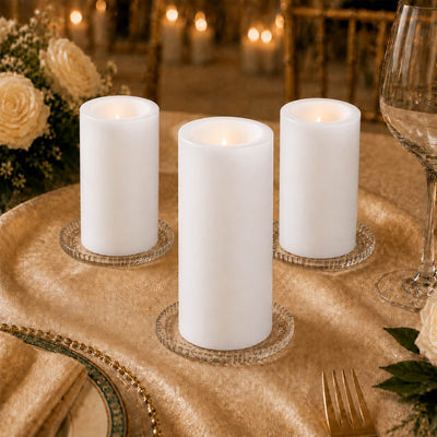 Elegant LED pillar candles on a gold table setting with floral decor