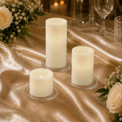 Elegant ivory LED pillar candles on a gold wedding table centerpiece