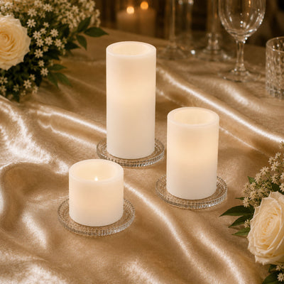 Elegant LED pillar candles on a gold table with roses and glassware