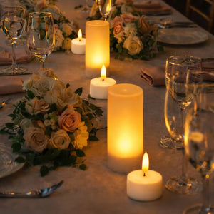 Elegant table setting with glowing candles and floral arrangements.