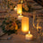 Elegant table setting with glowing candles and floral arrangements.