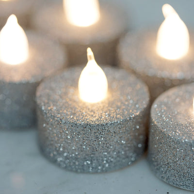 Glittering silver tealight candles with a warm glow.