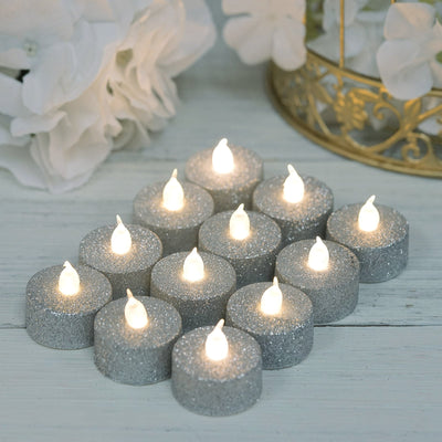 Silver glitter LED tea lights arranged in a decorative setting.