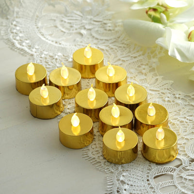 Set of 12 gold LED tea light candles on a decorative lace background.