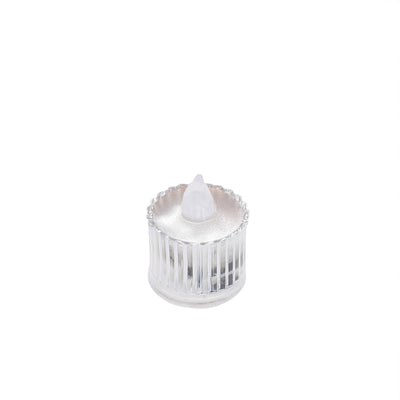 Clear glass candle holder with decorative ridges and a pointed top.