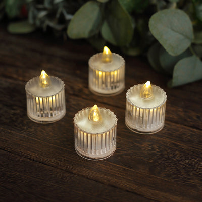 Set of four LED tea light candles with flickering flames.