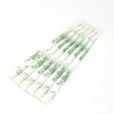 Decorative green floral candles in a set of six