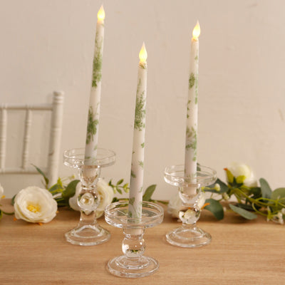 Elegant floral candle holders with candles, perfect for home decor.