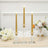 Elegant gold LED taper candles in glass holders with white floral centerpiece