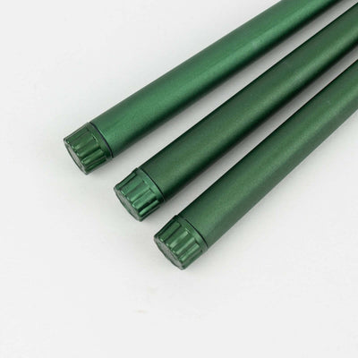 Green metal rods with textured ends on a white background