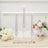 Elegant silver taper candles in clear glass holders with floral decor arrangement