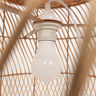White light bulb holder in woven rattan lamp shade.