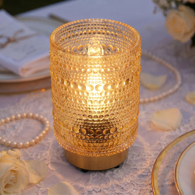Gold textured candle lantern on elegant wedding table centerpiece