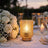 Elegant wedding table setting with white roses, candles, and champagne flutes