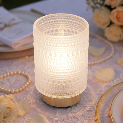 Elegant frosted glass LED candle holder on a romantic wedding table
